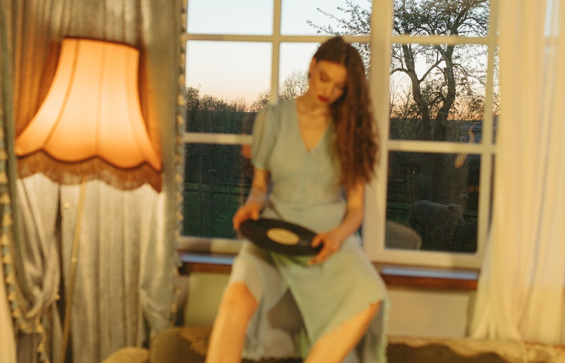 Woman Holding a Vinyl by the Window