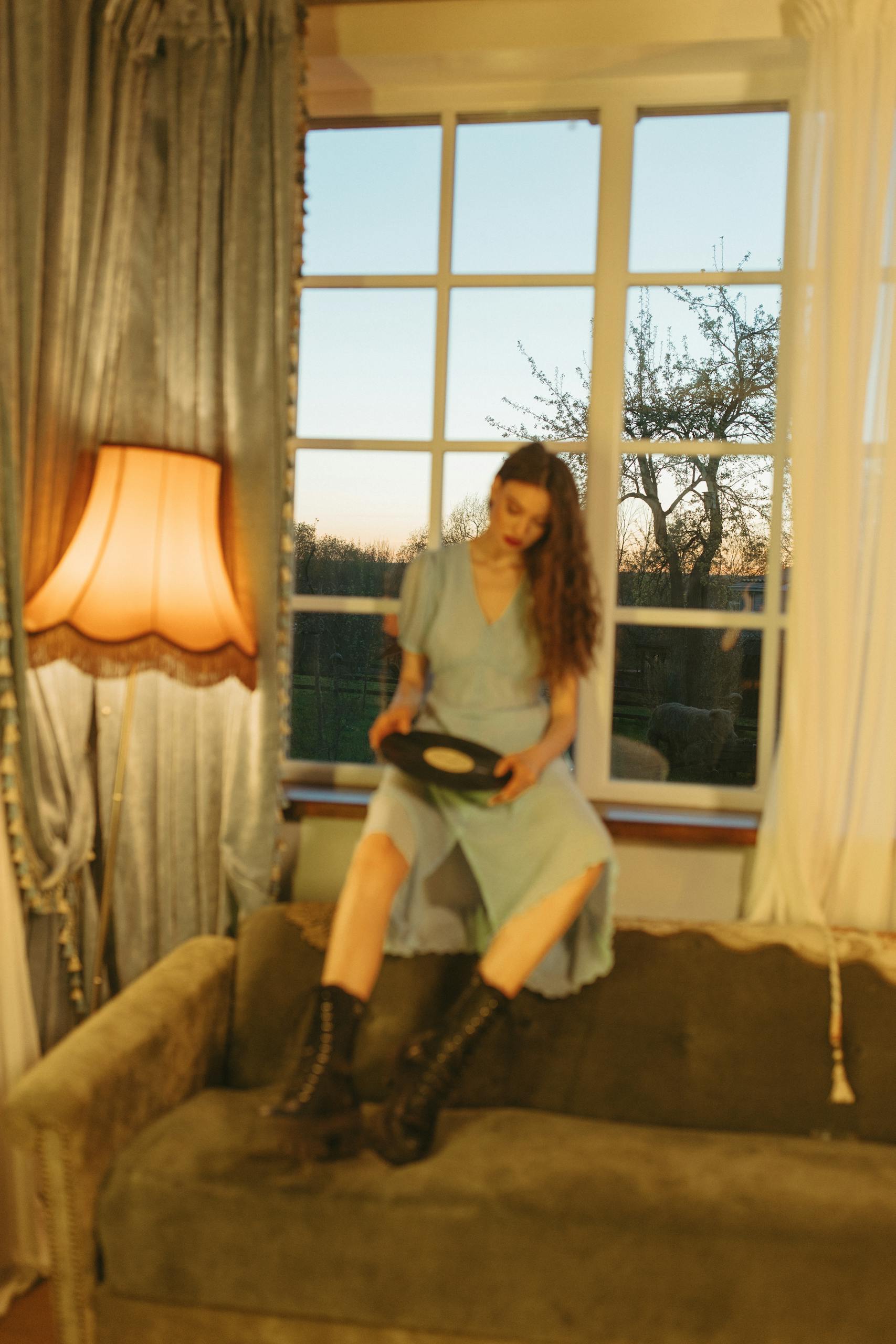 Woman Holding a Vinyl by the Window